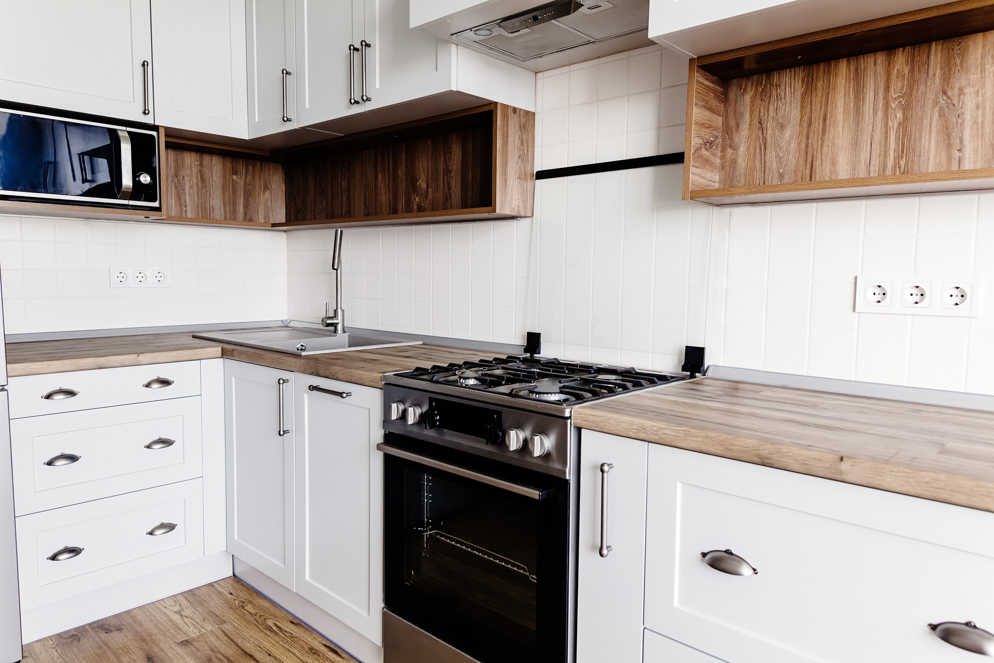 White kitchen with wood cabinetry