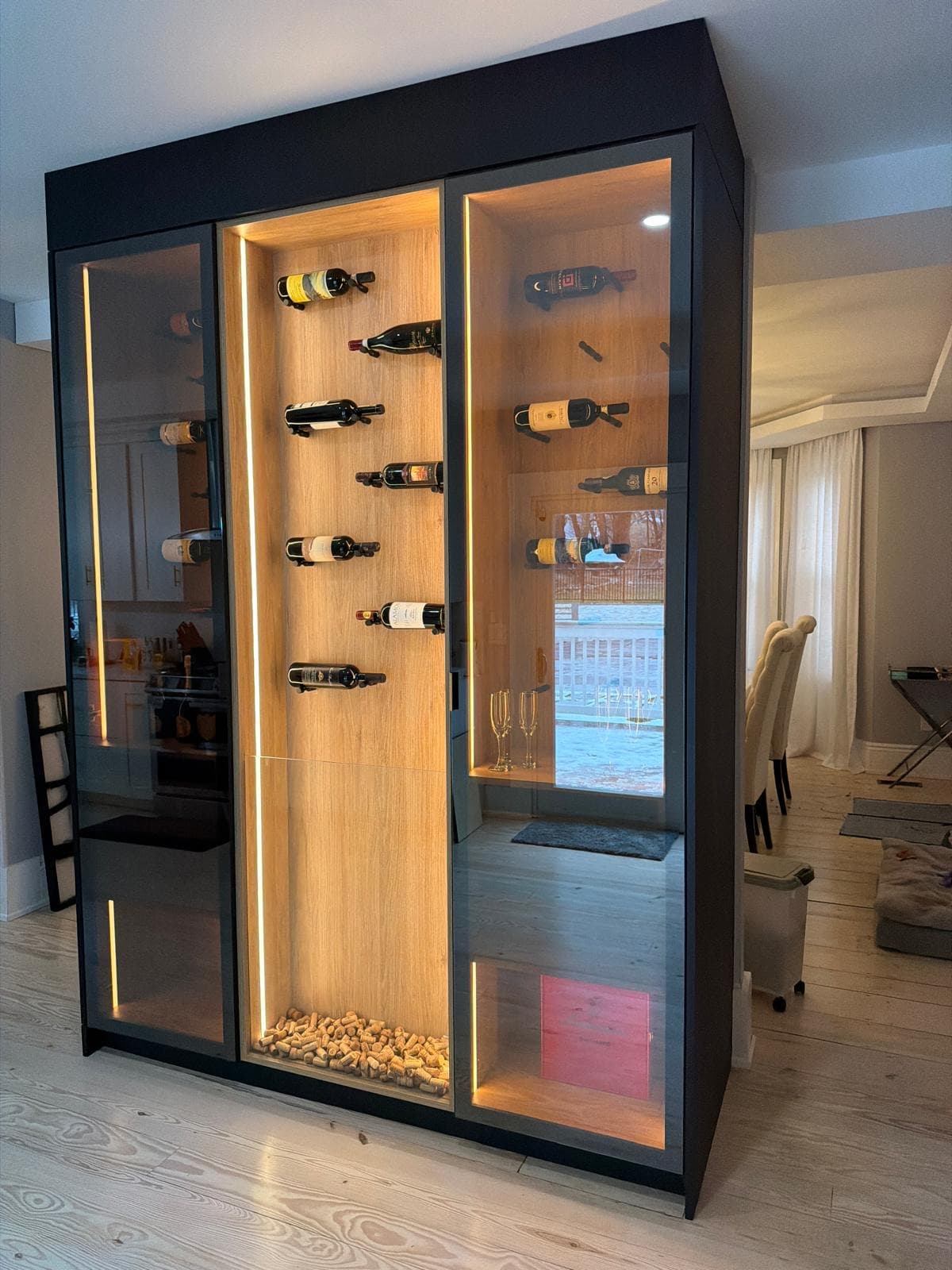 LED-lit custom glass wine display cabinet installed by Artnoble Finish Works