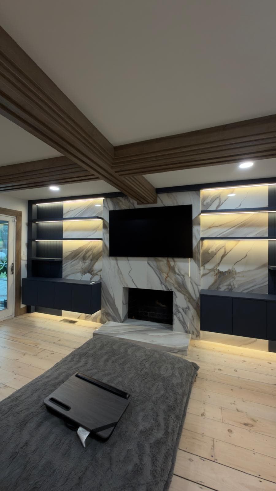 Built-in media wall and kitchen island in a modern Massachusetts home by Artnoble Finish Works
